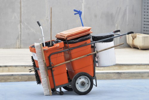 Company team arranging skip at Deptford street with high visibility signage